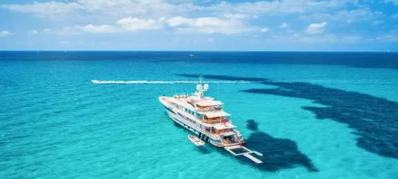 bahamas luxury yacht on anchor in clear turquoise water