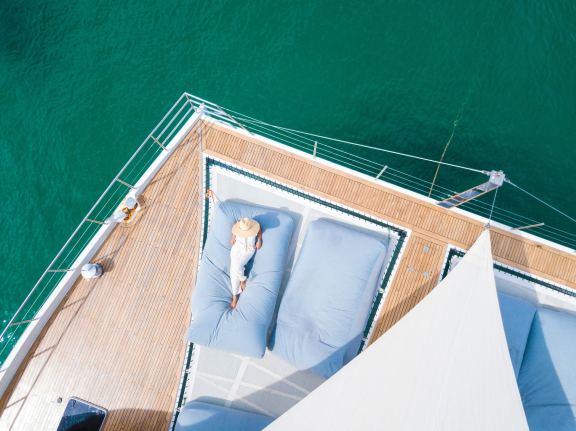 A woman sunbathing on a catamaran