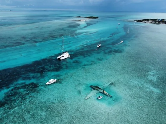 Boats Anchored Around a Plane Wreck at Norman's Cay, Bahamas