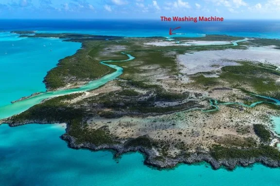 This stunning aerial photo shows Shroud Cay in the Bahamas, beautifully capturing its diverse landscape and vibrant turquoise waters. The image highlights the intricate network of mangroves and the meandering channels that snake through the cay, which are typical of this area. These channels are shallow enough to explore by kayak or paddleboard, allowing visitors to navigate through the serene natural environment closely. The surrounding waters, famous for their clarity and richness in marine life, offer fantastic opportunities for snorkeling. This secluded area is a perfect example of the unspoiled beauty of the Exumas, providing a peaceful escape in a natural setting.