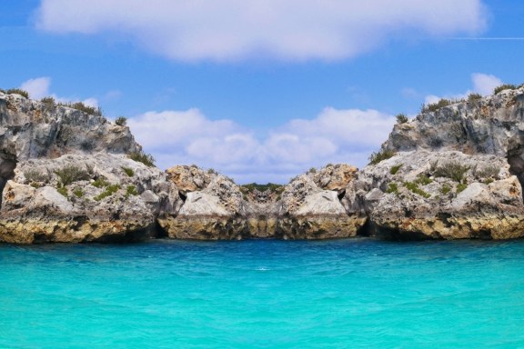 This image showcases the striking entrance to Thunderball Grotto in the Bahamas, an iconic underwater cave known for its use in the James Bond film 