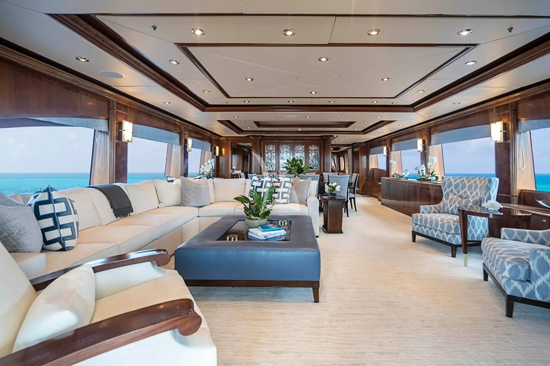 CAMILLE salon with pale sofas, wood panelling and ocean views