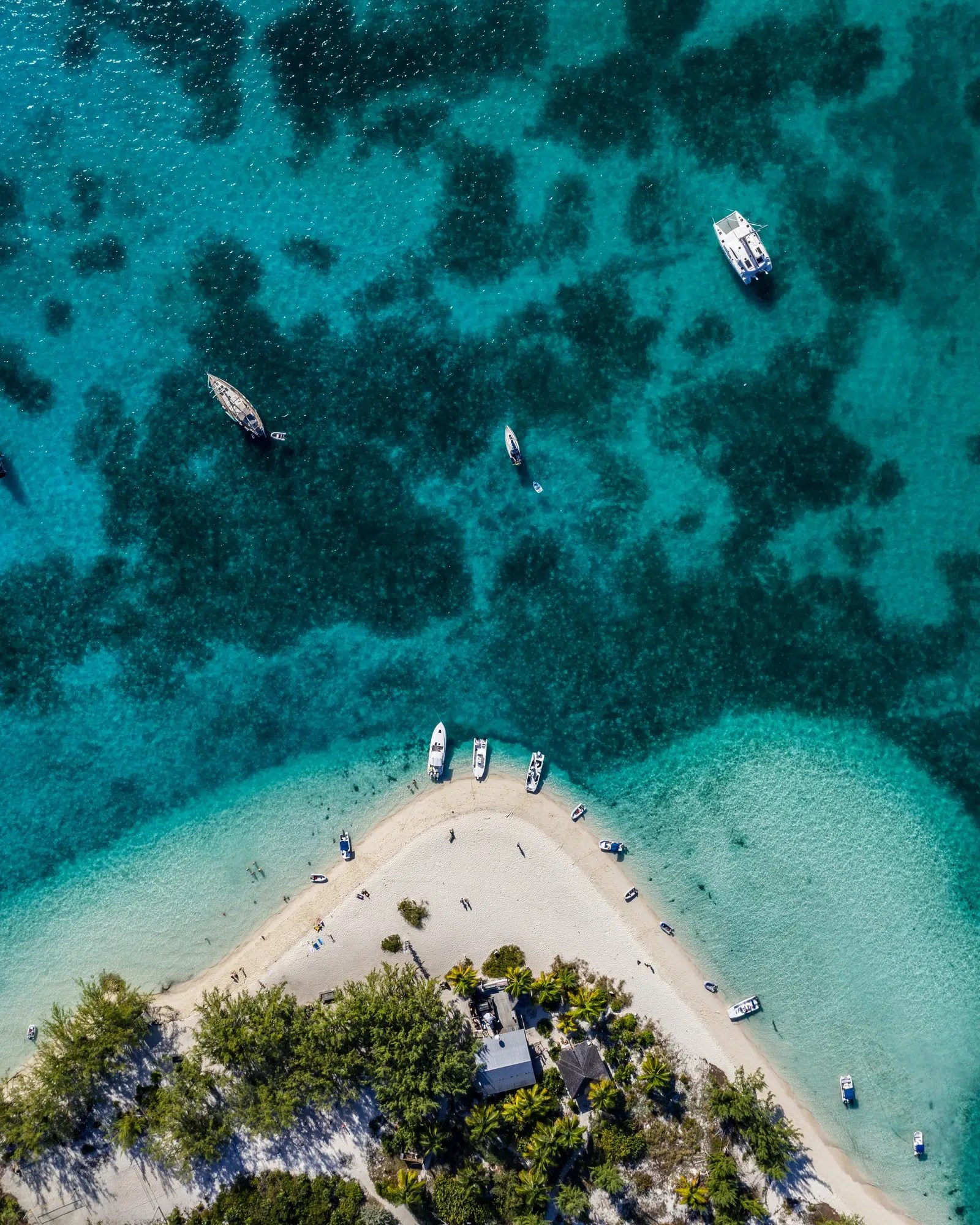 An overhead view of the sandy point, tenders and turquoise water on Stocking Island, Exuma, Bahamas