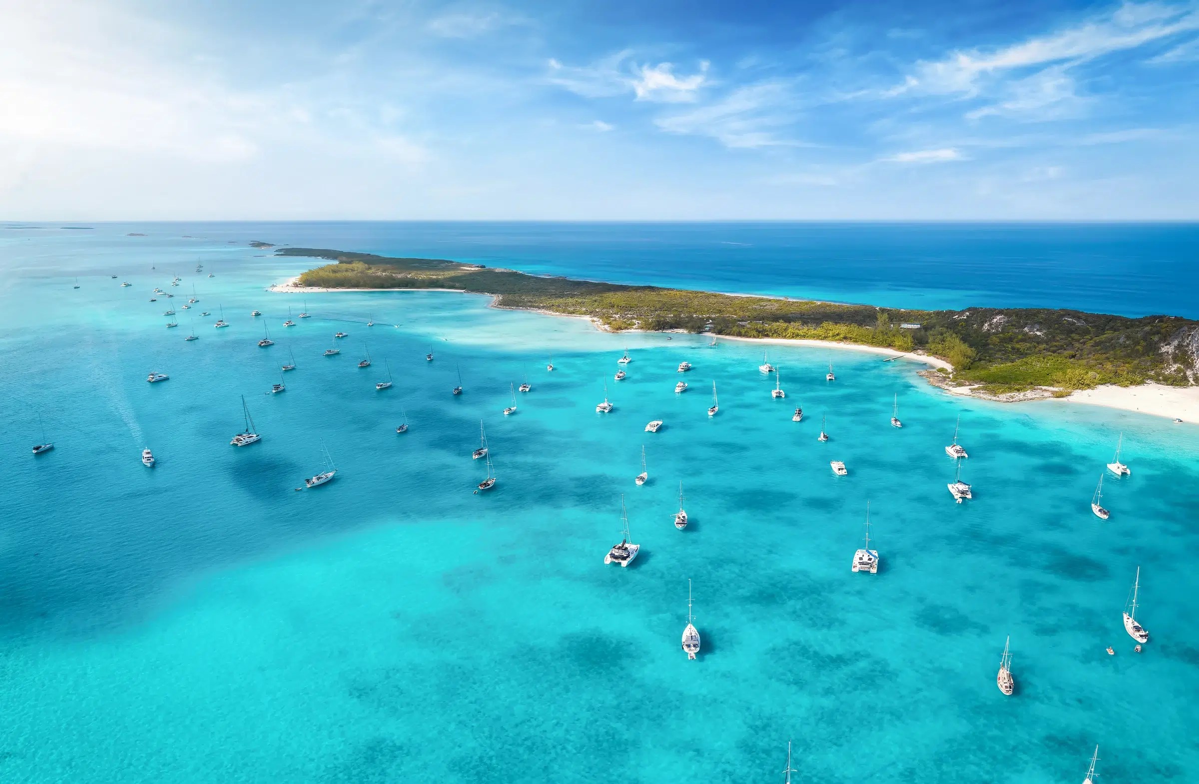 Boats anchored beside Starfish and Coconut Beach on Stocking Island in the Exumas, Bahamas