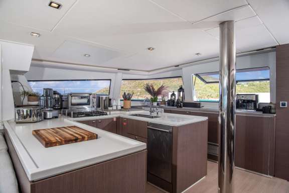 The main salon is open and inviting. It has a telescopic table that can be lowered to the height of a coffee table or raised and opened up for a dining table that can easily accommodate 8 guests.